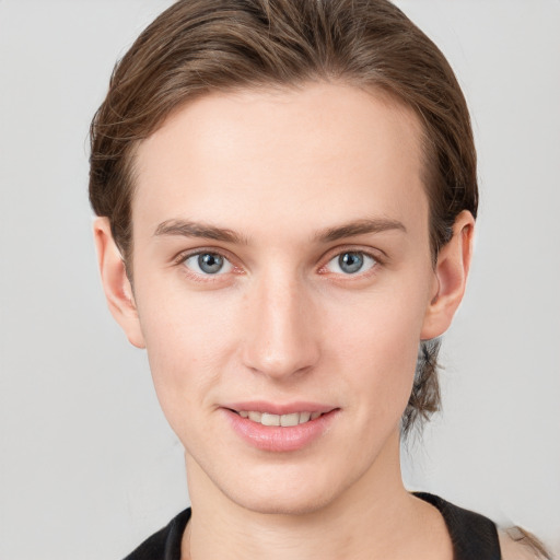 Joyful white young-adult female with medium  brown hair and grey eyes