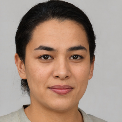 Joyful asian young-adult female with short  brown hair and brown eyes
