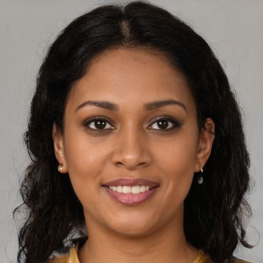 Joyful black young-adult female with long  brown hair and brown eyes
