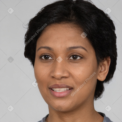 Joyful black young-adult female with short  black hair and brown eyes