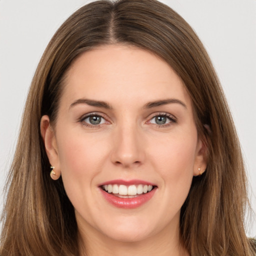 Joyful white young-adult female with long  brown hair and brown eyes