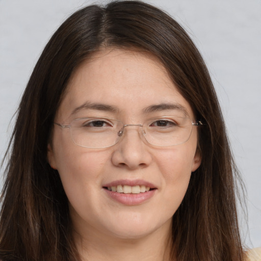 Joyful white adult female with long  brown hair and brown eyes