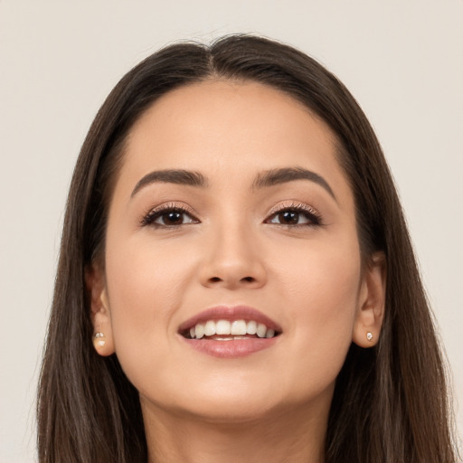 Joyful white young-adult female with long  brown hair and brown eyes