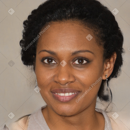 Joyful black adult female with medium  brown hair and brown eyes