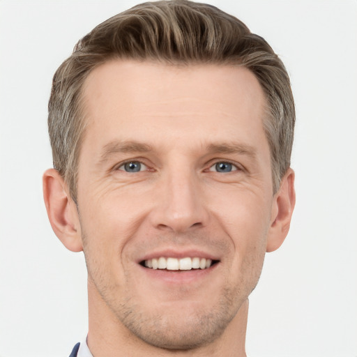 Joyful white adult male with short  brown hair and grey eyes