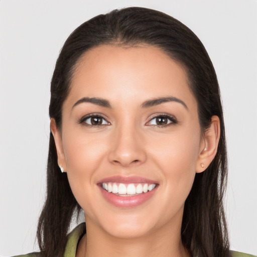 Joyful white young-adult female with long  brown hair and brown eyes