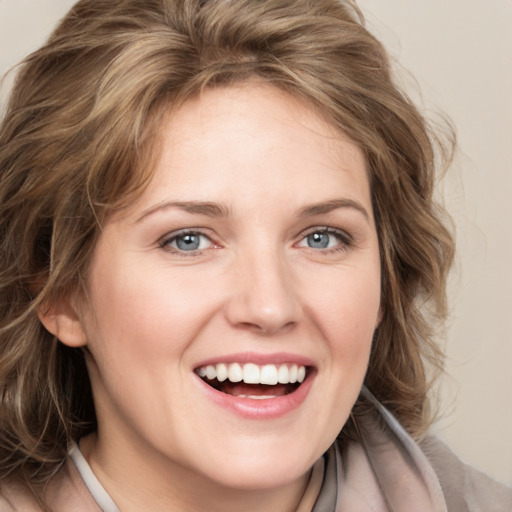 Joyful white young-adult female with medium  brown hair and blue eyes