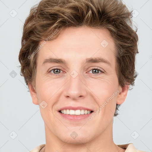 Joyful white young-adult female with short  brown hair and grey eyes