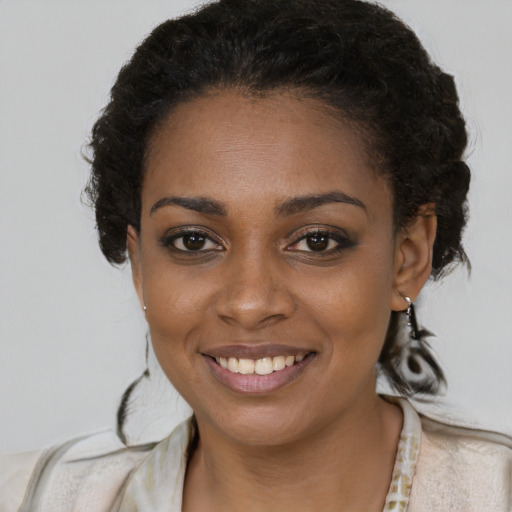 Joyful black young-adult female with medium  brown hair and brown eyes
