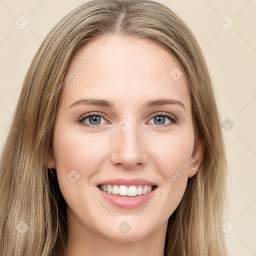 Joyful white young-adult female with long  brown hair and green eyes