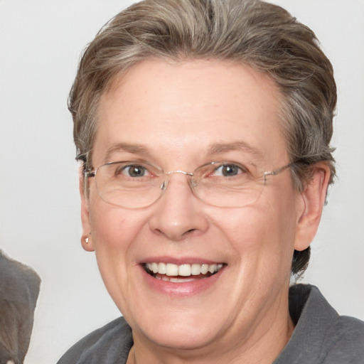 Joyful white adult female with medium  brown hair and blue eyes