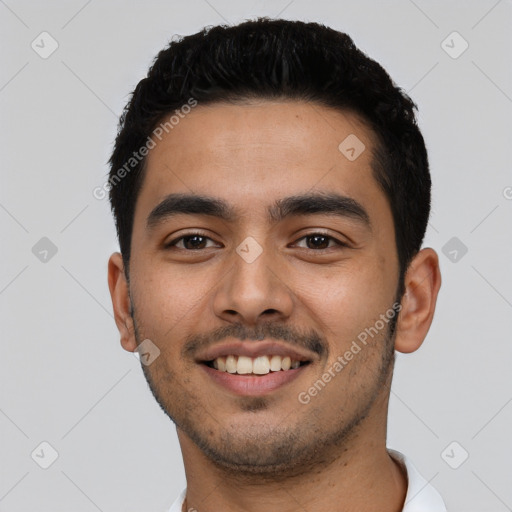 Joyful latino young-adult male with short  black hair and brown eyes