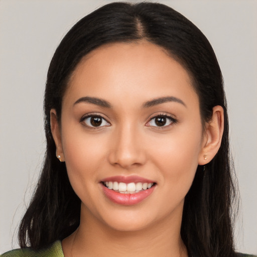 Joyful latino young-adult female with long  black hair and brown eyes