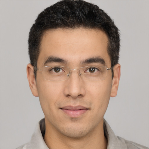 Joyful white young-adult male with short  black hair and brown eyes