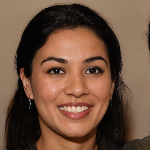 Joyful latino young-adult female with medium  brown hair and brown eyes