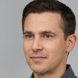 Joyful white adult male with short  brown hair and brown eyes