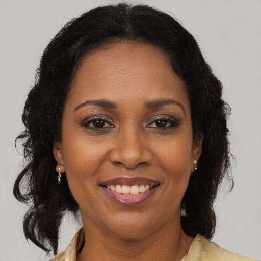 Joyful black adult female with medium  brown hair and brown eyes