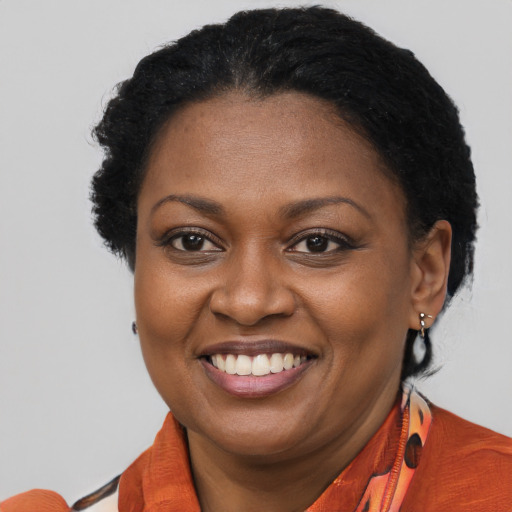 Joyful black adult female with short  brown hair and brown eyes