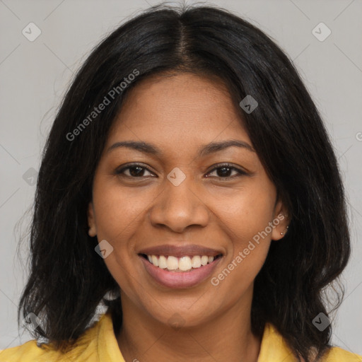 Joyful black young-adult female with long  brown hair and brown eyes