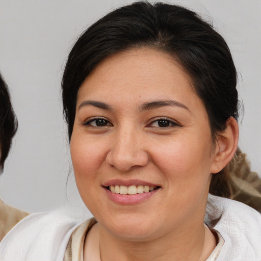Joyful white adult female with medium  brown hair and brown eyes