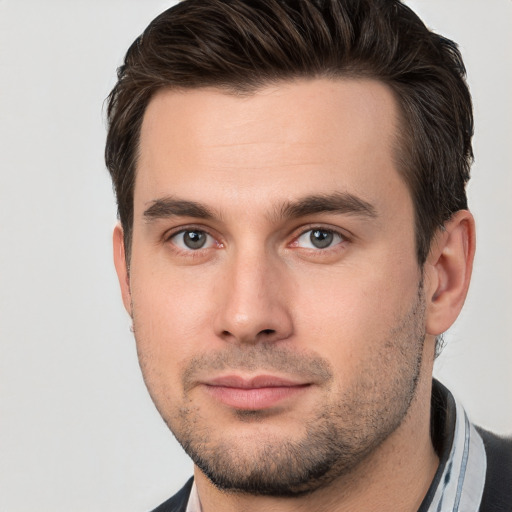 Joyful white young-adult male with short  brown hair and brown eyes