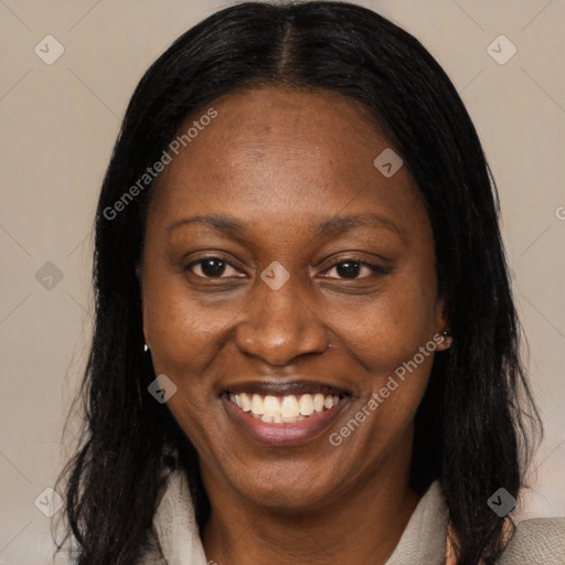 Joyful black adult female with medium  brown hair and brown eyes