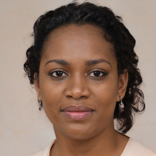 Joyful black young-adult female with medium  black hair and brown eyes