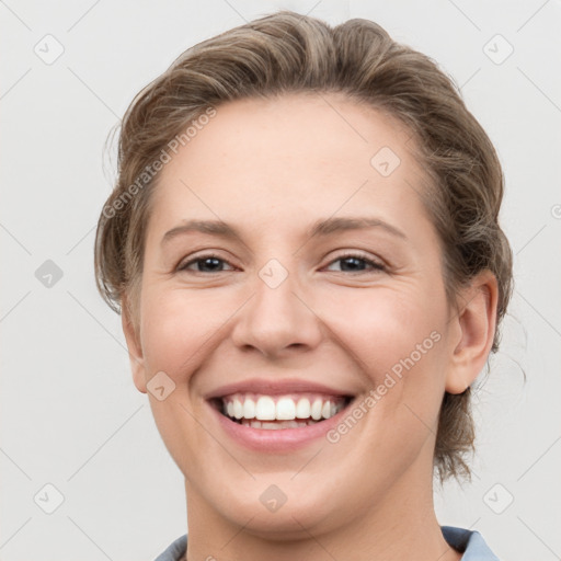 Joyful white young-adult female with short  brown hair and grey eyes