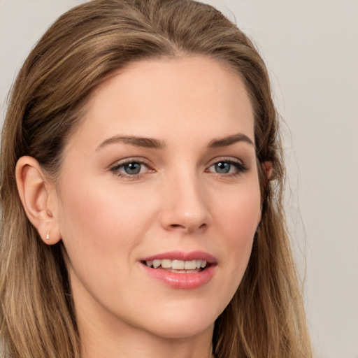 Joyful white young-adult female with long  brown hair and grey eyes