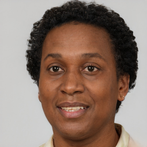 Joyful black adult female with short  brown hair and brown eyes
