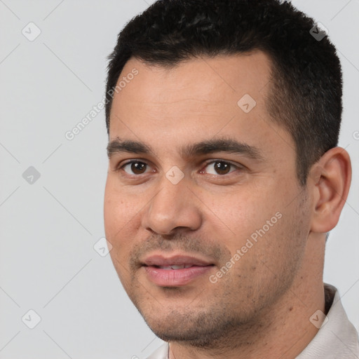 Joyful white young-adult male with short  black hair and brown eyes