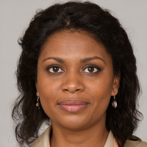 Joyful black young-adult female with medium  brown hair and brown eyes