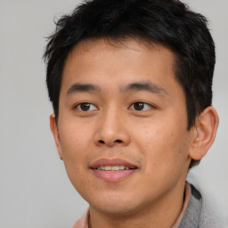 Joyful asian young-adult male with short  brown hair and brown eyes