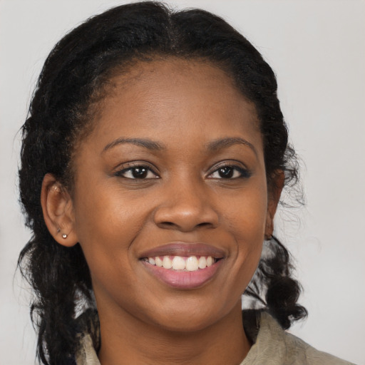 Joyful black young-adult female with medium  brown hair and brown eyes