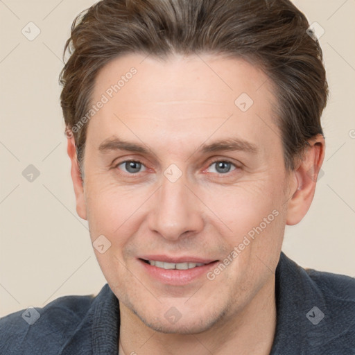 Joyful white adult male with short  brown hair and grey eyes