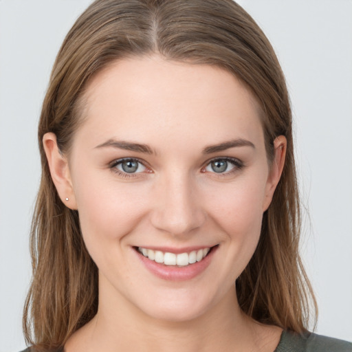 Joyful white young-adult female with medium  brown hair and grey eyes