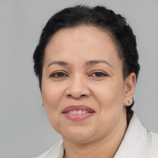 Joyful latino adult female with short  brown hair and brown eyes