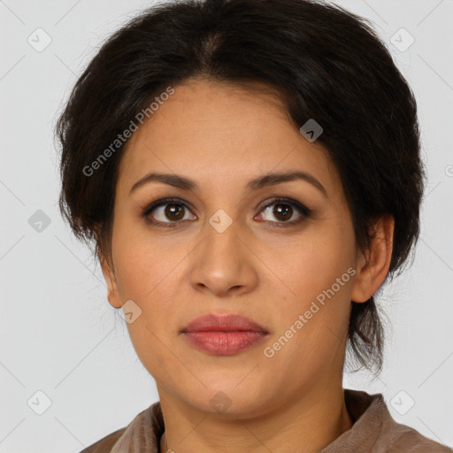 Joyful latino adult female with medium  brown hair and brown eyes