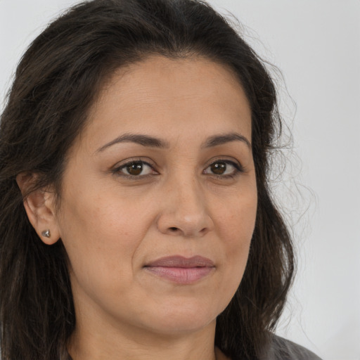 Joyful white adult female with long  brown hair and brown eyes