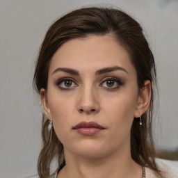 Neutral white young-adult female with medium  brown hair and brown eyes