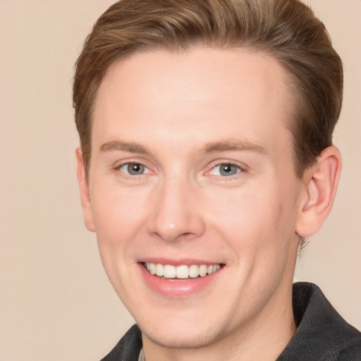 Joyful white adult male with short  brown hair and grey eyes