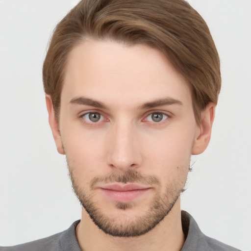 Joyful white young-adult male with short  brown hair and grey eyes