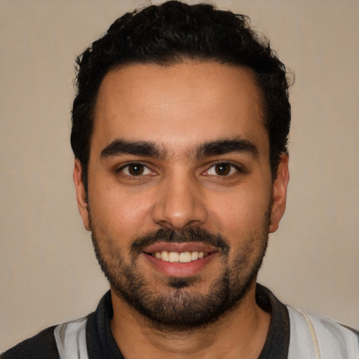 Joyful latino young-adult male with short  black hair and brown eyes