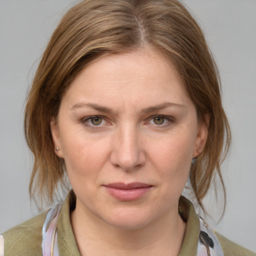 Joyful white young-adult female with medium  brown hair and blue eyes