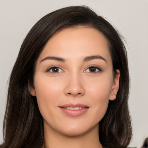 Joyful white young-adult female with long  brown hair and brown eyes