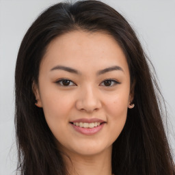 Joyful asian young-adult female with long  brown hair and brown eyes