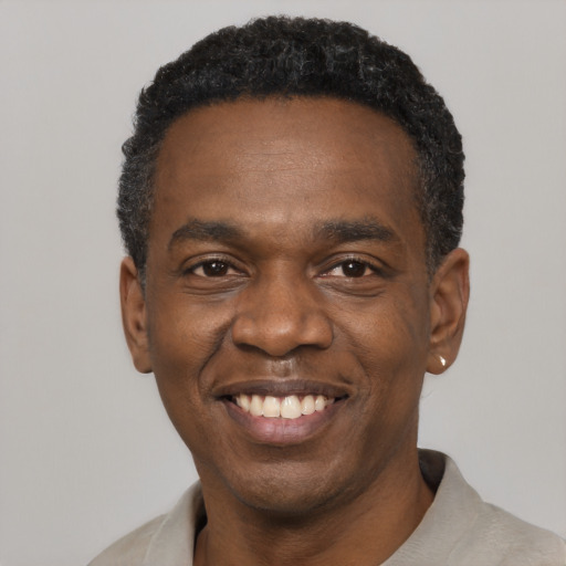 Joyful latino adult male with short  black hair and brown eyes