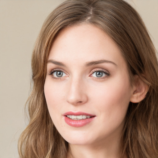 Joyful white young-adult female with long  brown hair and green eyes