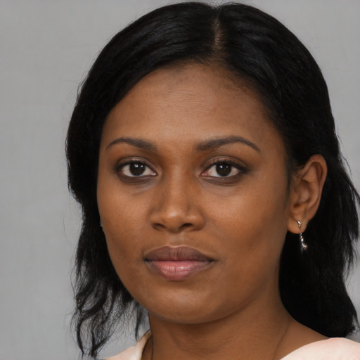 Joyful black young-adult female with medium  black hair and brown eyes
