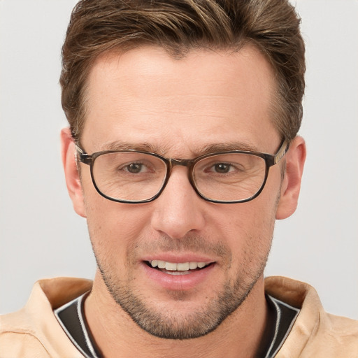 Joyful white adult male with short  brown hair and grey eyes